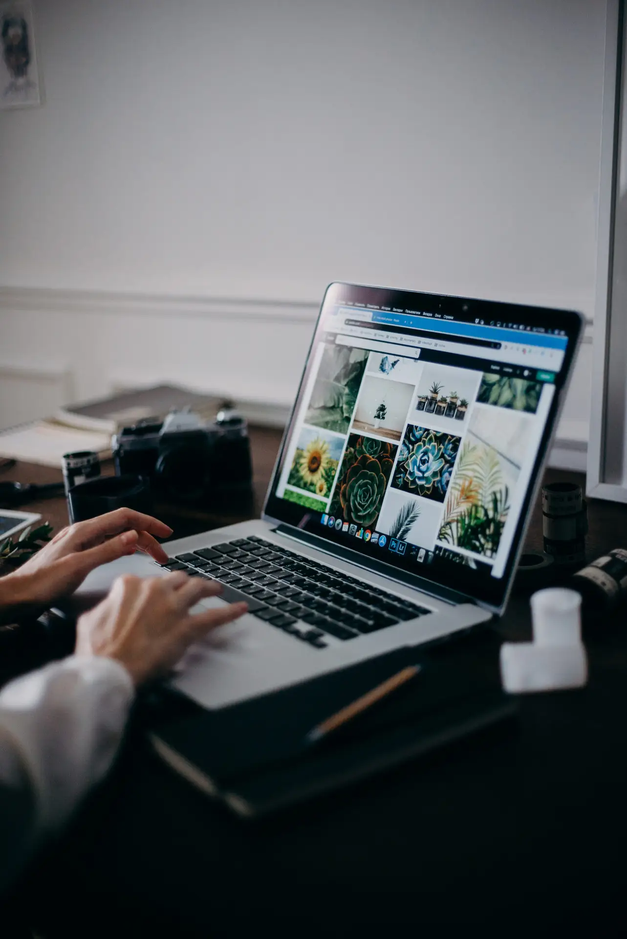 person using macbook pro on table